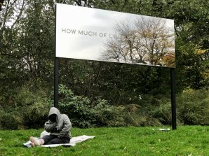 A sign reading "How much of love is attention?" from Chloë Bass's "Wayfinding," St. Nicholas Park, Harlem, 2019