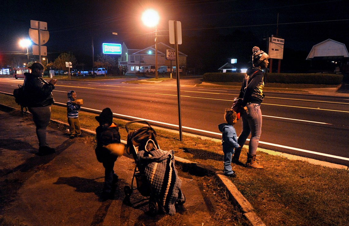 Families waiting for the bus to downtown Atlanta after their homeless shelter’s 6:00 AM checkout time