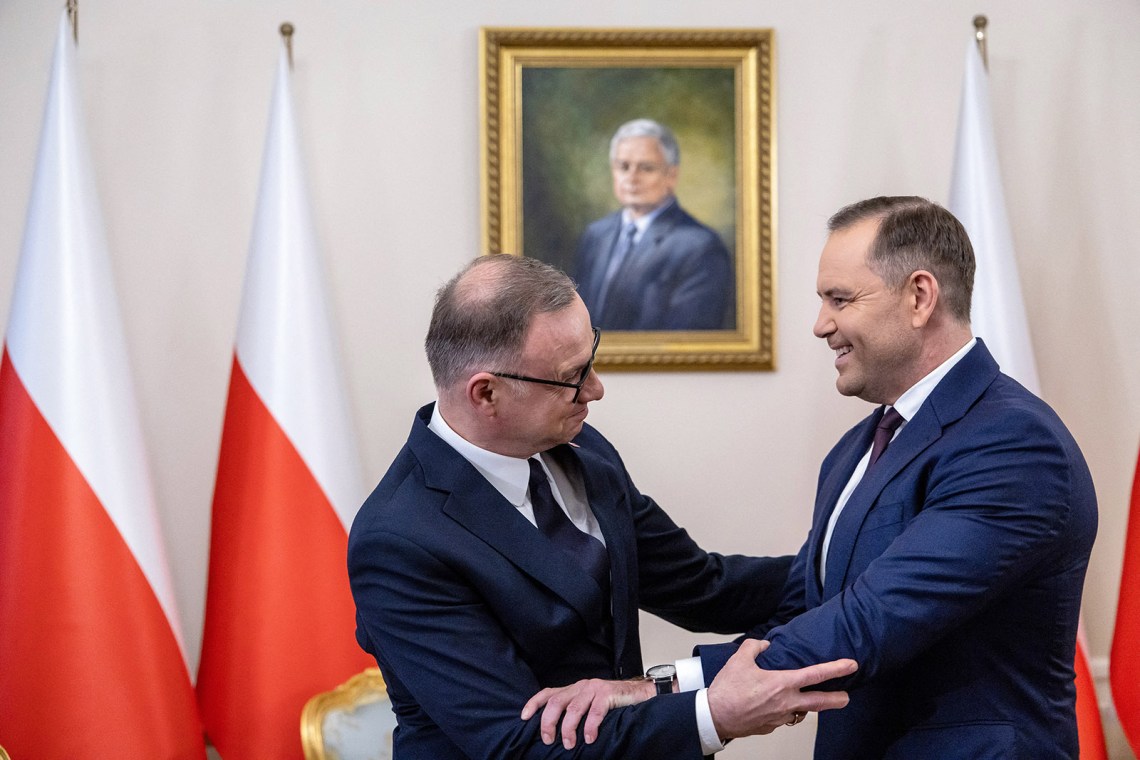 President Andrzej Duda and President-elect Karol Nawrocki in front of a portrait of the late former president Lech Kaczyński at the Presidential Palace, Warsaw