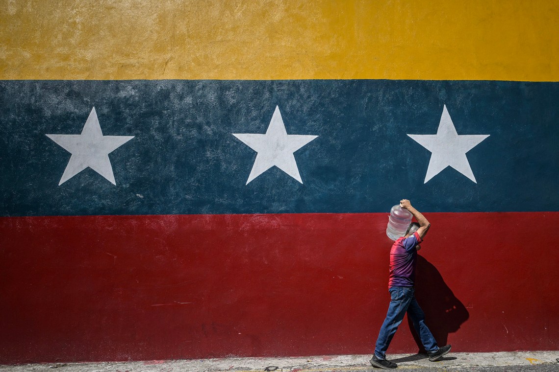 A man carrying a drum of water, Caracas, Venezuela