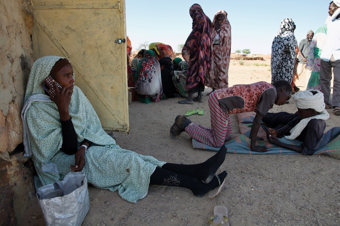 People in Dar Zaghawa, northwestern Darfur, gathering at one of the few places in the area with a Starlink Internet connection to try to get news of their ­relatives in El-Fasher